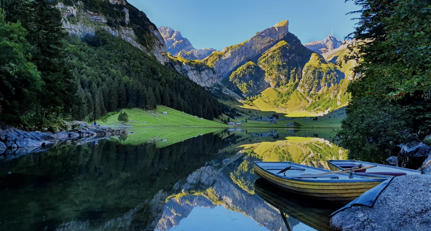 A beautiful alipine lake with a rowboat in the foreground